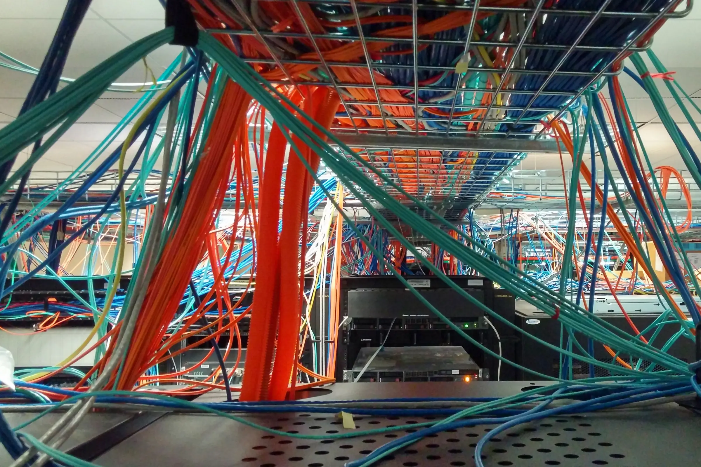 Bundles of coloured network cables in a data centre